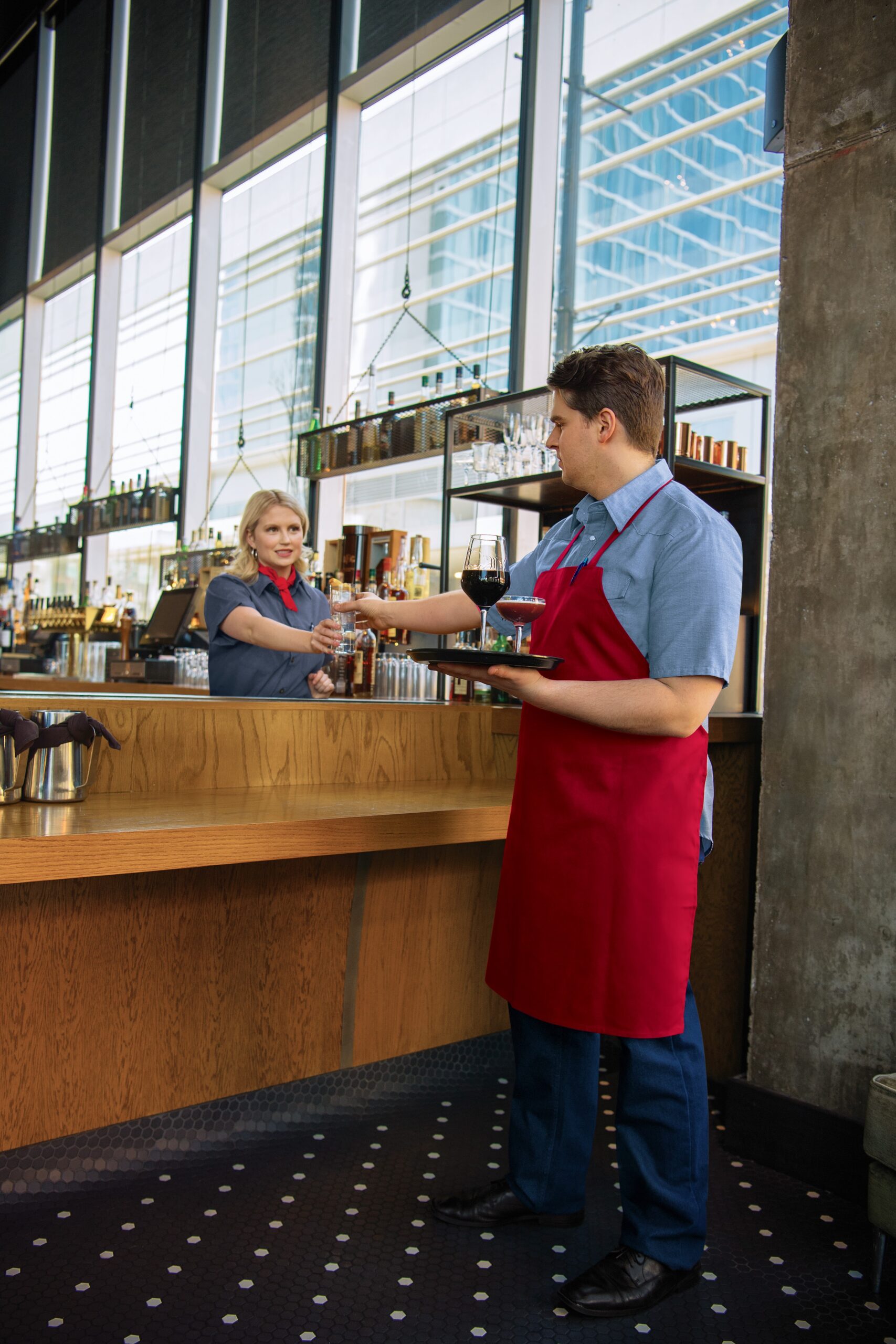 Server employee wearing a red apron