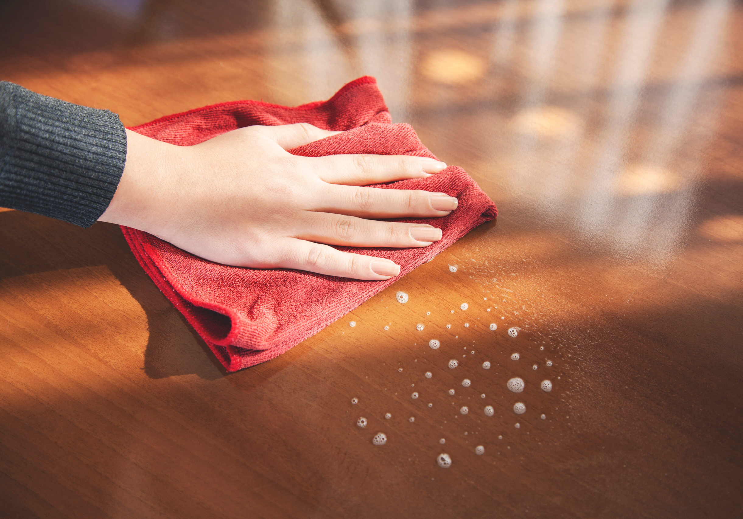 young house woman cleaning on wooden table